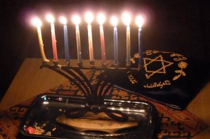 A lit menorah on a table