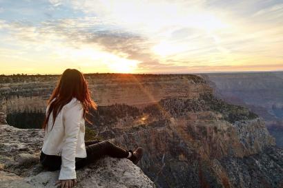 Student sitting on the edge of the Grand Canyon