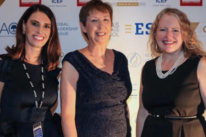 Dr. Mary Dwyer stands in a black dress next to two other women at WIE event