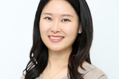 headshot of Sunyeon Lee who has long dark hair and is wearing a tan shirt