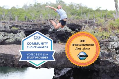 Top Study Abroad Organization 2019 badges from Go Overseas and GoAbroad on a picture of a woman jumping in front of a rocky water outcrop