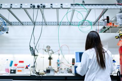 Female engineer in the lab with her back to the camera