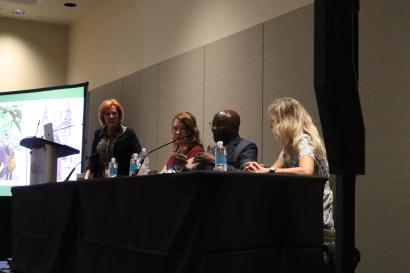 Panel of 4 people during an IES Global presentation at NAFSA 2026; Michael Adewumi speaking.