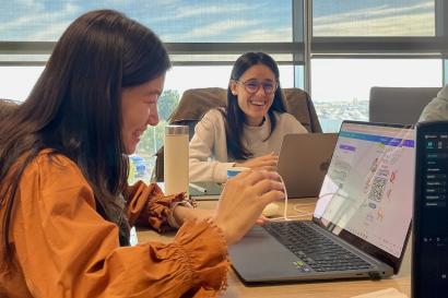 Eunsung and a coworker laughing as they work on the AbroadIES app's promotional materials.