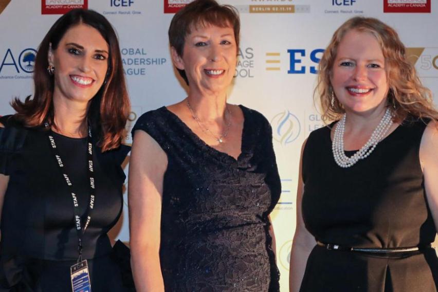 Dr. Mary Dwyer stands in a black dress next to two other women at WIE event