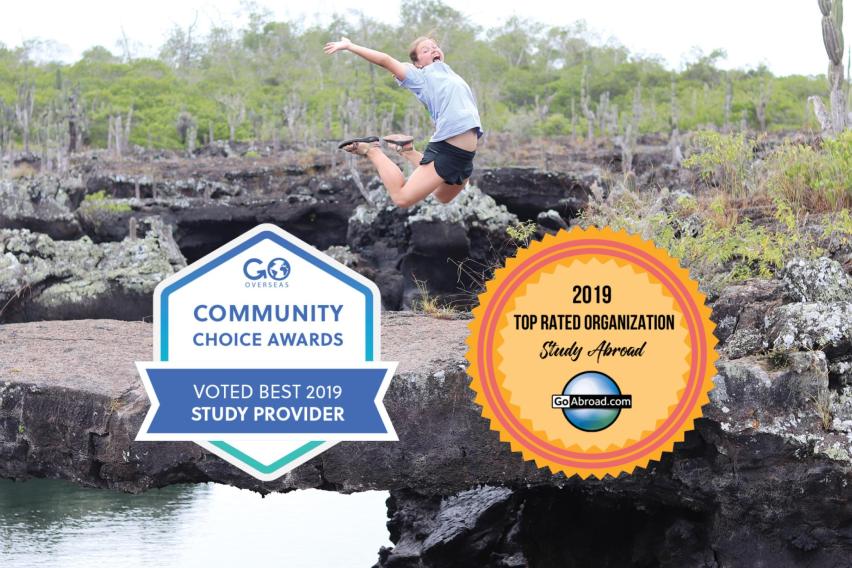 Top Study Abroad Organization 2019 badges from Go Overseas and GoAbroad on a picture of a woman jumping in front of a rocky water outcrop