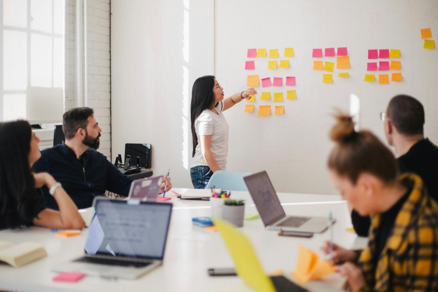 An intern makes a presentation to colleagues at her work experience placement.