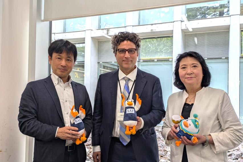 Brett Rumminger, Director of SAF Japan, with Sagami Women's University staff, all holding SAFFY plushies.