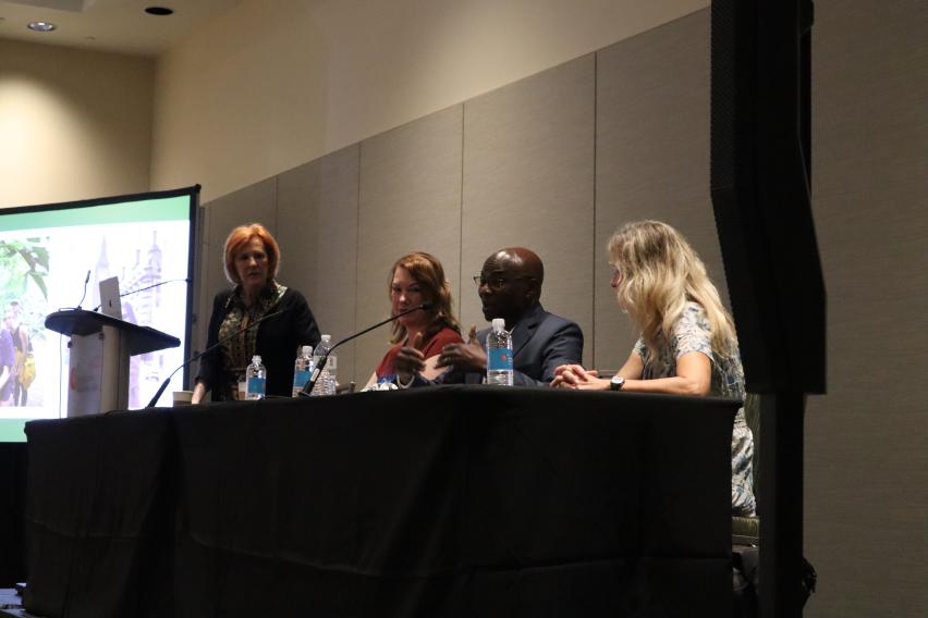 Panel of 4 people during an IES Global presentation at NAFSA 2026; Michael Adewumi speaking.
