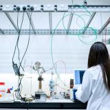Female engineer in the lab with her back to the camera