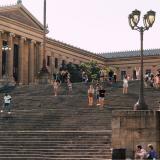 tourists pose on the steps outside the Philadelphia Museum of Art