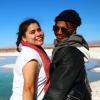 two students stand arm-in-arm in front of lagoons in San Pedro de Atacama, Chile