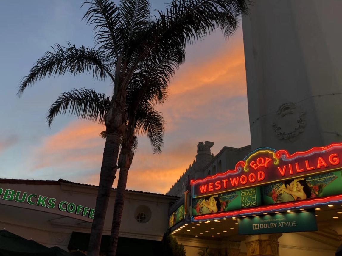 LA Westwood Village neon sign with sunset sky