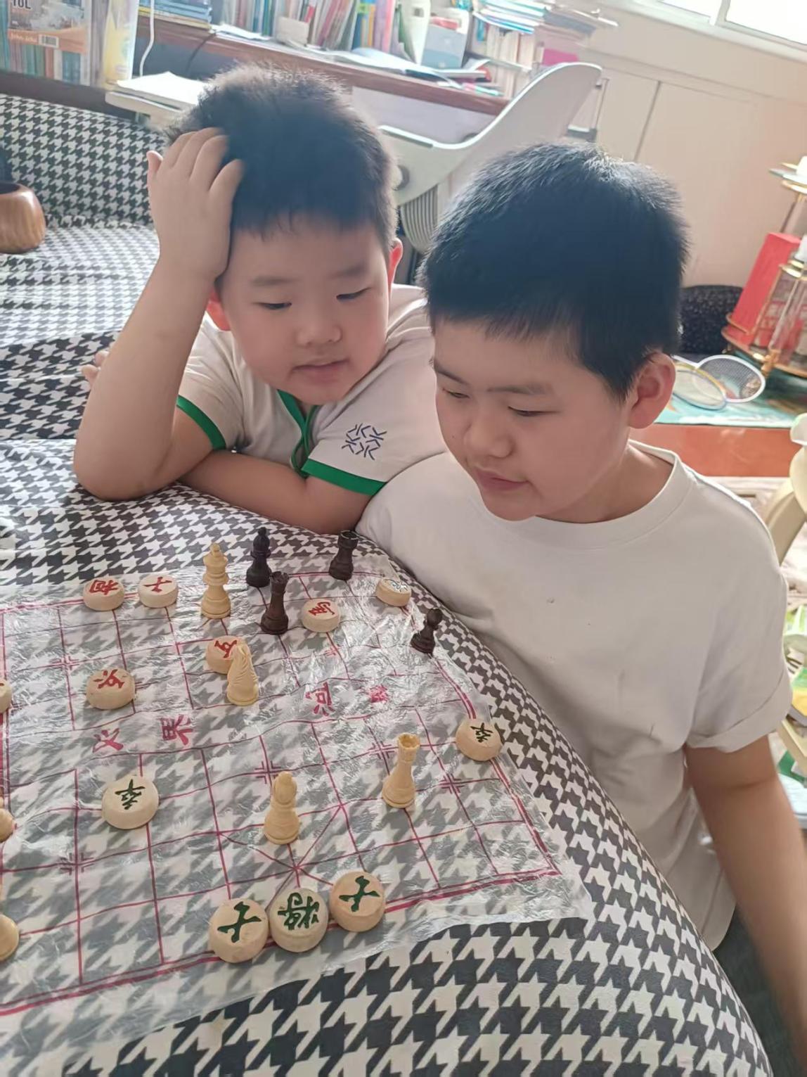 Staff member Gorden Xie's two boys playing a game together.