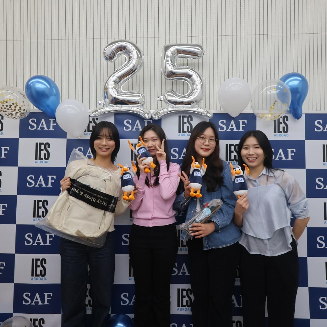 SAF Alumni Event - Students in front of 25th Anniversary banner
