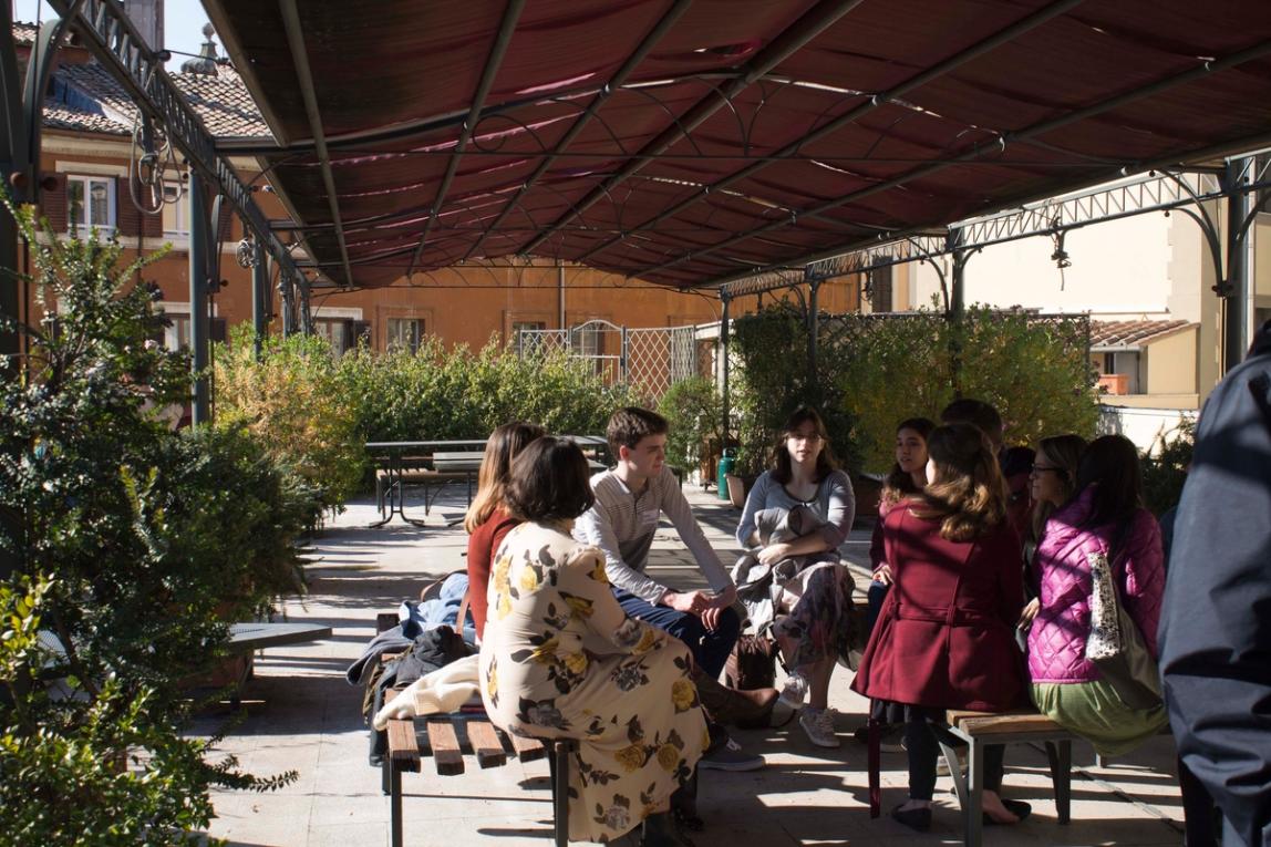 Students sitting underneath the patio gazebo of the IES Abroad Rome Center.