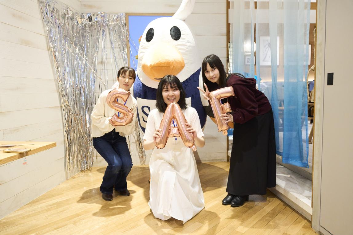3 students with the SAFFY mascot, each student holding a letter which spell "SAF".