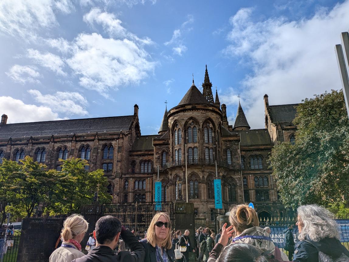 Front of the University of Glasgow with a group of people in the foreground.