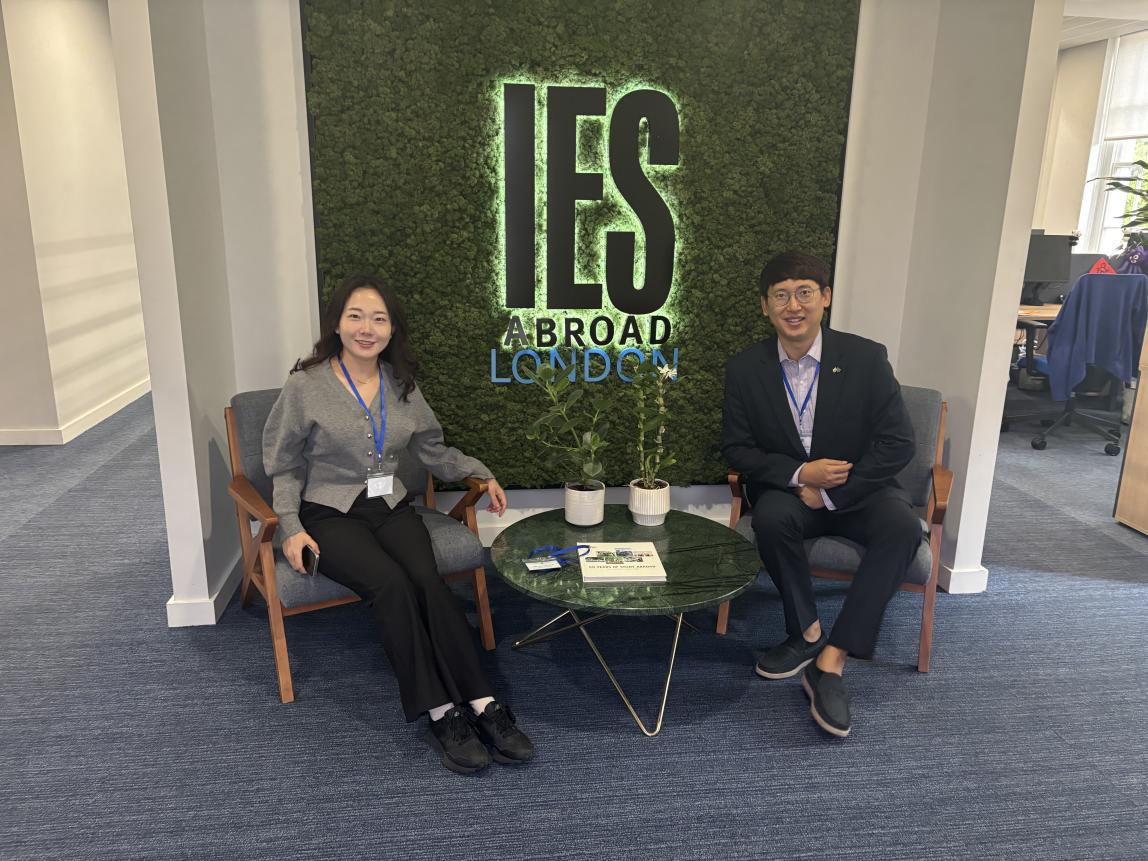 Staff from Chonnam National University sitting in front of the IES Abroad London Center sign.
