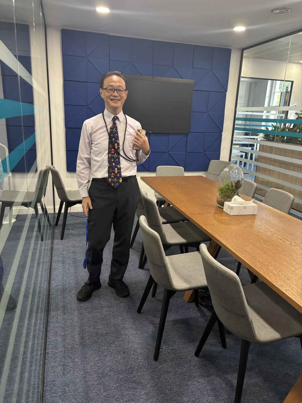 Professor Ashizawa (KUIS) posing in a meeting room at the IES Abroad London Center.