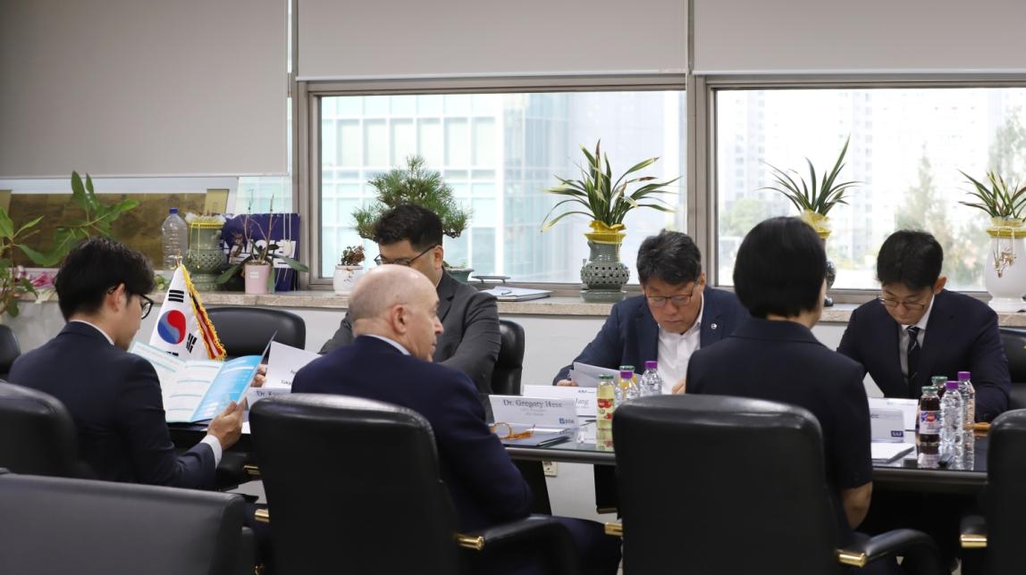 Dr. Greg Hess and Soongsil University faculty having a table meeting.