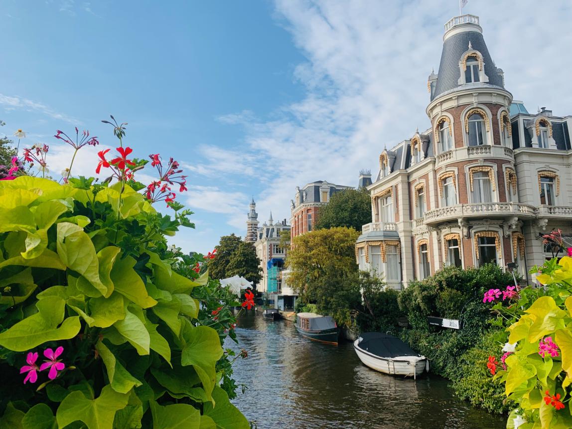 flowers in front of an Amsterdam canal and typical architecture