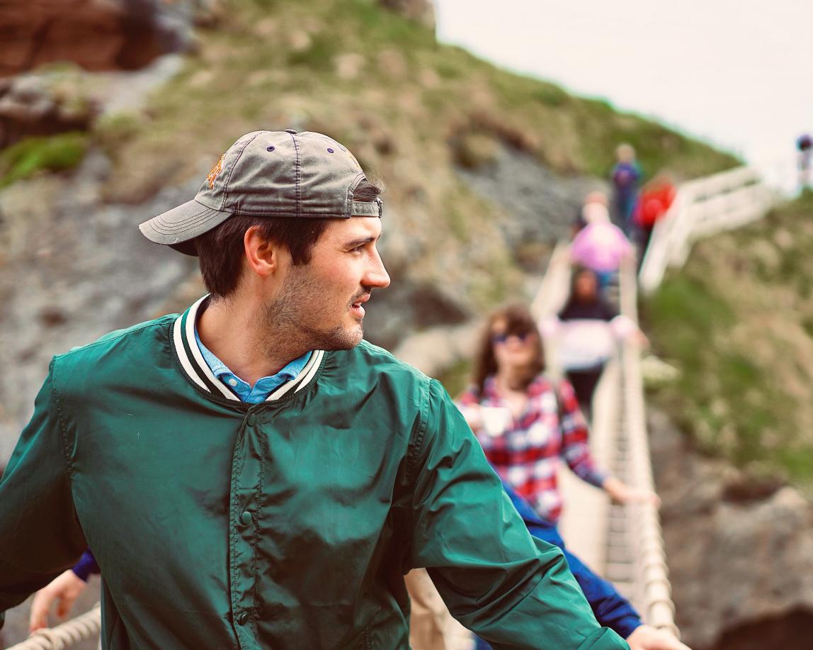 a candid photo of a student crossing a bridge in Ireland