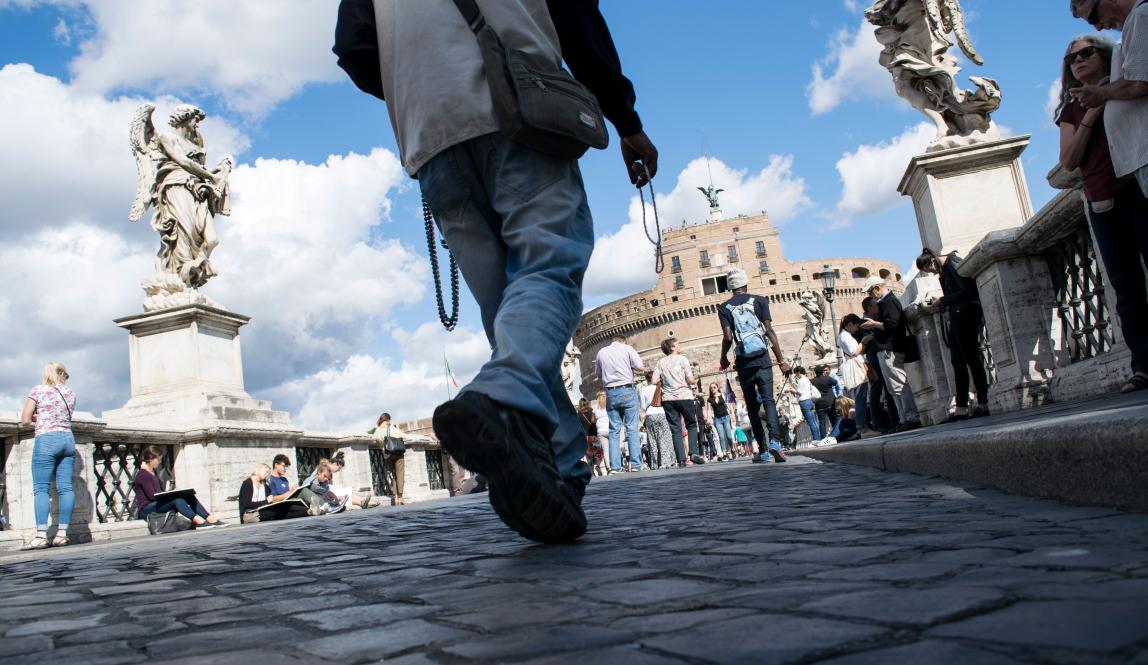 an artistic shot of people's feet as they walk toward Castel Sant'Angelo