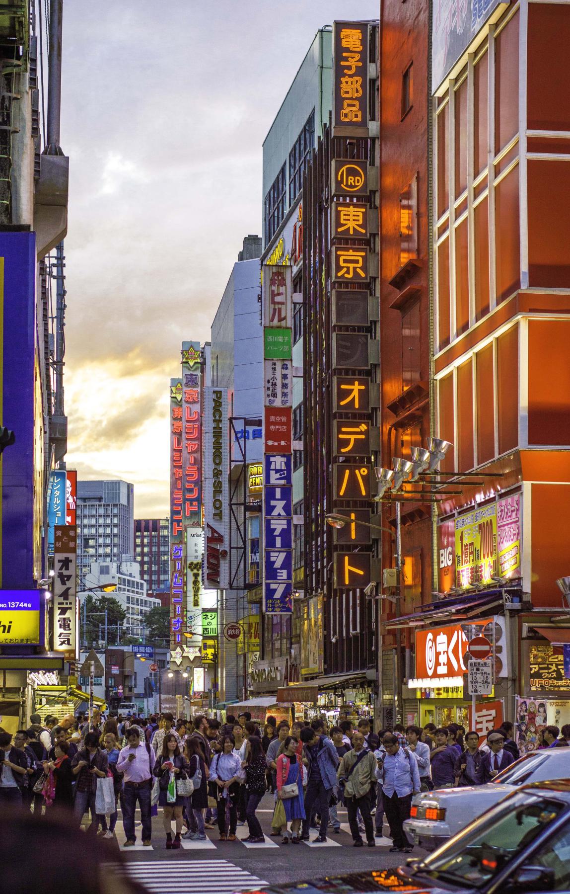 the neon lights and crowd-filled street in Akihabara, Tokyo