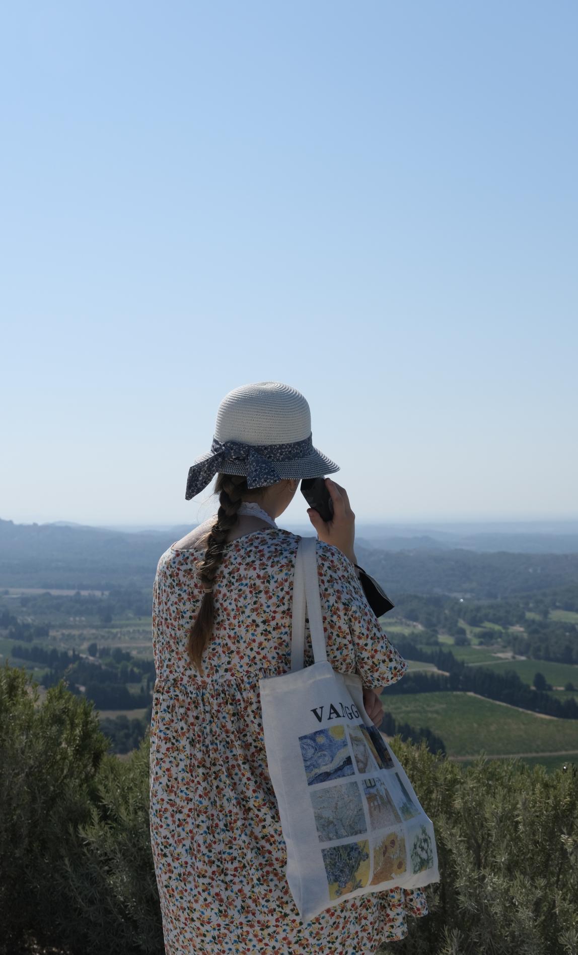 A student looks out over the green landscape of Beaux de Provence, France.