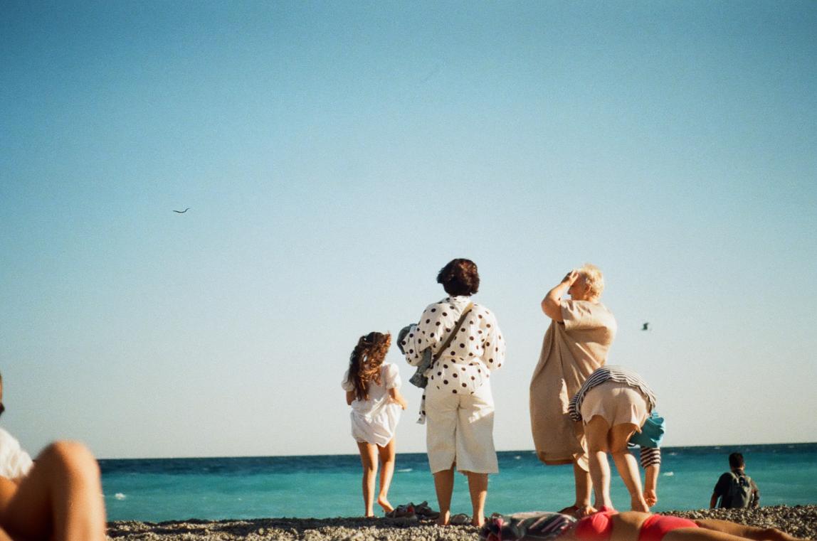 A family stands on the beach in Nice, France.