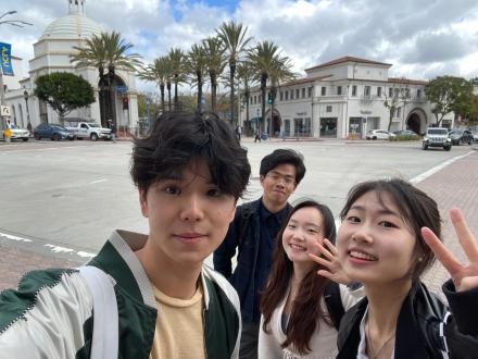 UCLA Big Data & Business Application students pose for a photo at UCLA in front of palm trees