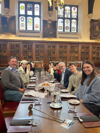 digital marketing students in London dine in a wood-panelled room with lecturers and experts