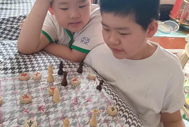Staff member Gorden Xie's two boys playing a game together.