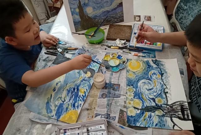 Staff member Gorden Xie's two boys painting Van Gogh's Starry Night together.