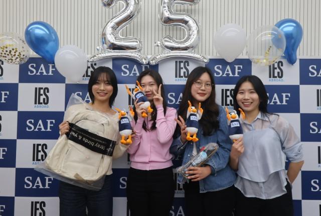 SAF Alumni Event - Students in front of 25th Anniversary banner