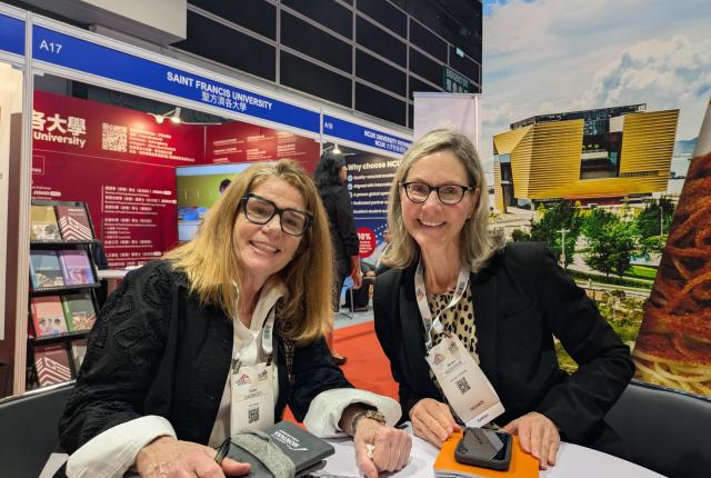 Carol Carmody with a partner from University of Montana at APAIE 2026.