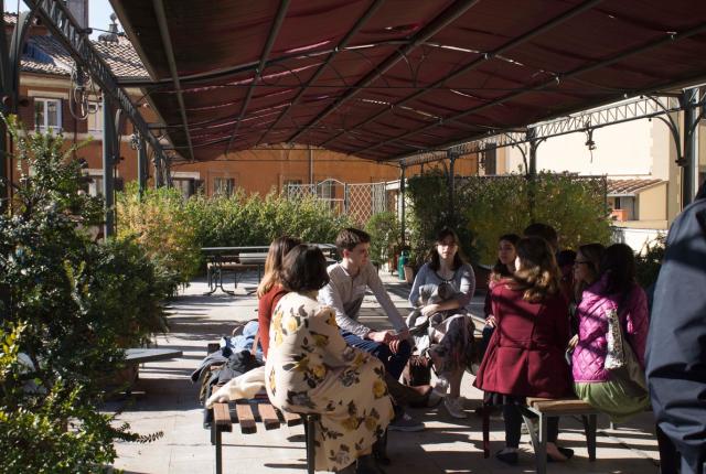 Students sitting underneath the patio gazebo of the IES Abroad Rome Center.