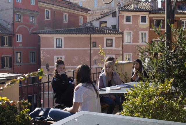 Group of female students conversing on the outside patio of the IES Abroad Rome Center.