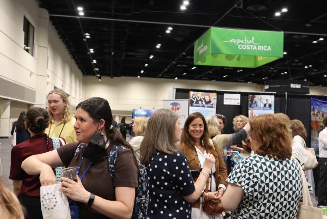 Group of attendees at NAFSA 2026 chatting inside the convention.