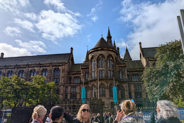 Front of the University of Glasgow with a group of people in the foreground.