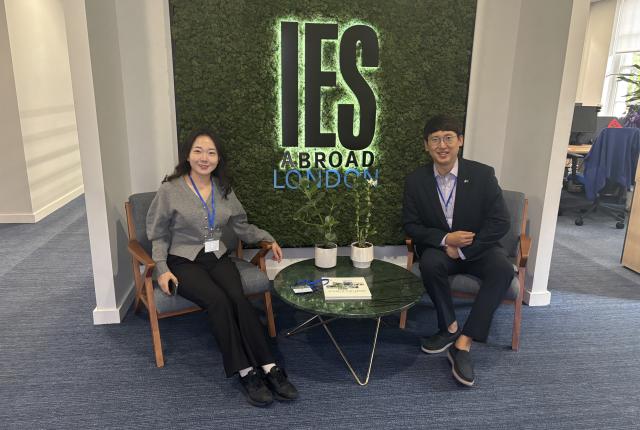 Staff from Chonnam National University sitting in front of the IES Abroad London Center sign.