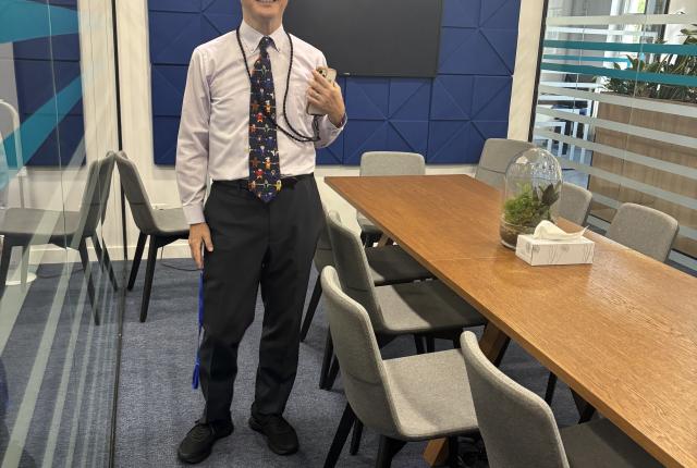 Professor Ashizawa (KUIS) posing in a meeting room at the IES Abroad London Center.