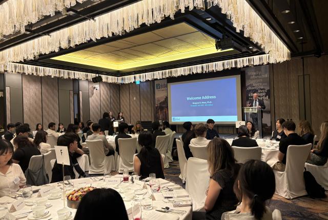 Dr. Greg Hess presenting in front of the crowd at the 2026 SAF Korea Alumni Event.