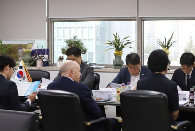 Dr. Greg Hess and Soongsil University faculty having a table meeting.