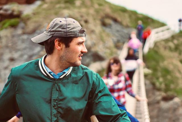 a candid photo of a student crossing a bridge in Ireland