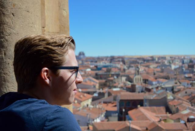 a student looking out over Salamanca from the rooftops