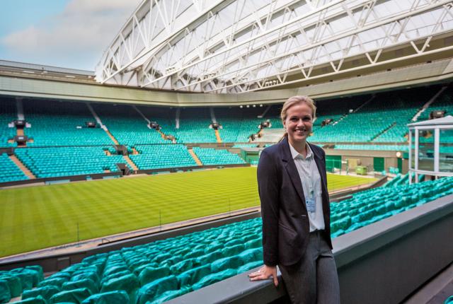 a student intern standing in an empty sports arena