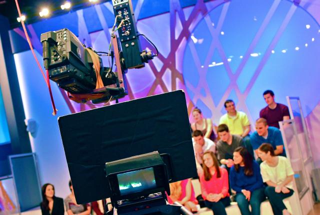 a studio audience behind a camera in Milan