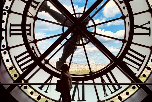 a student's silhouette behind a clock tower at Musee D'orsay